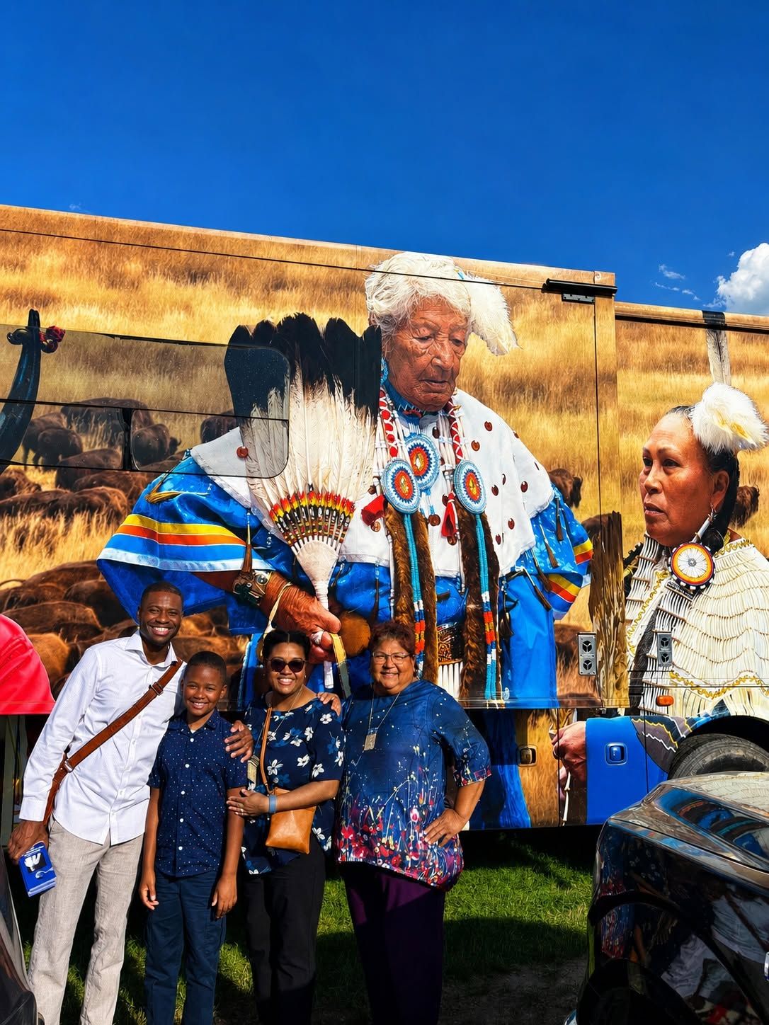 Terrence Davis with family and a friend in front of a painted mural